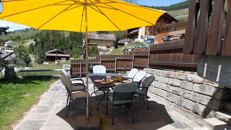 The great patio with a large table and a big yellow parasol