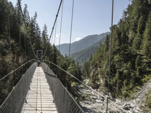 Suspension bridge over mountain stream